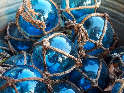Blue fishing floats in netting